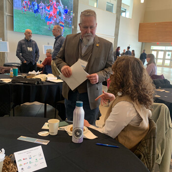 Brian Ilnicki (left) chats with Lexi Maxwell, one of the forum presenters.